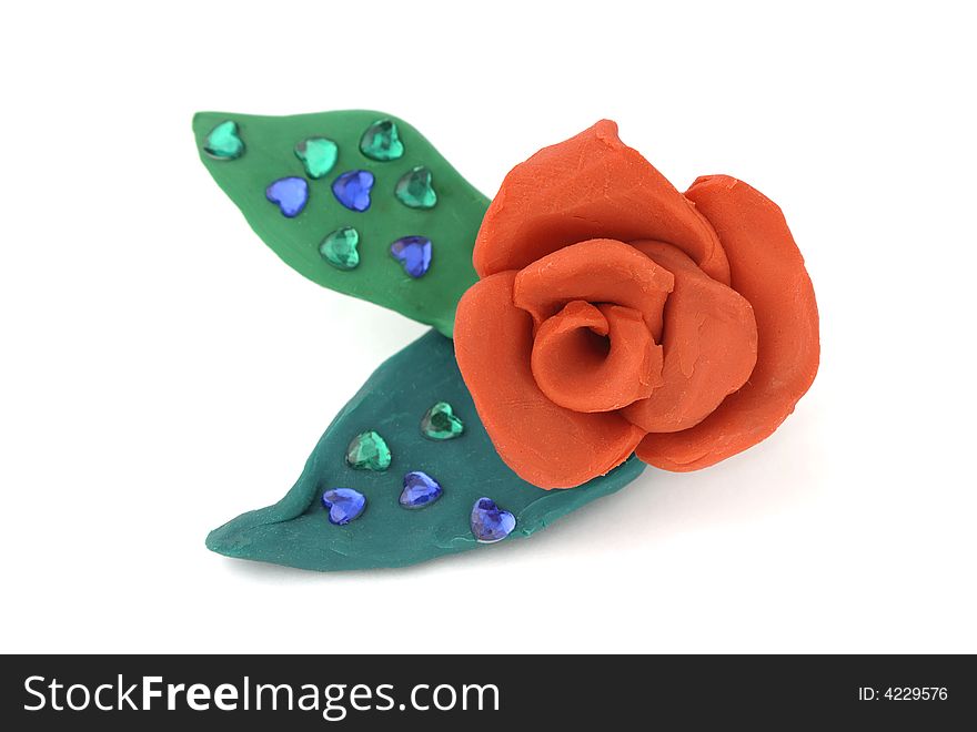 Red rose with leaves made of plasticine