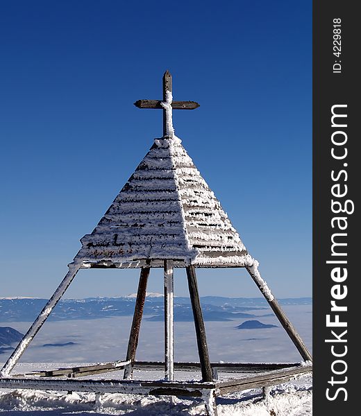 A cross at the top of a mountain