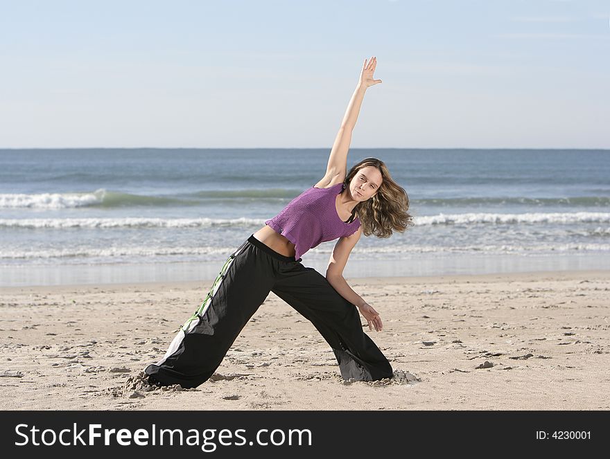 Woman stretching at the beach