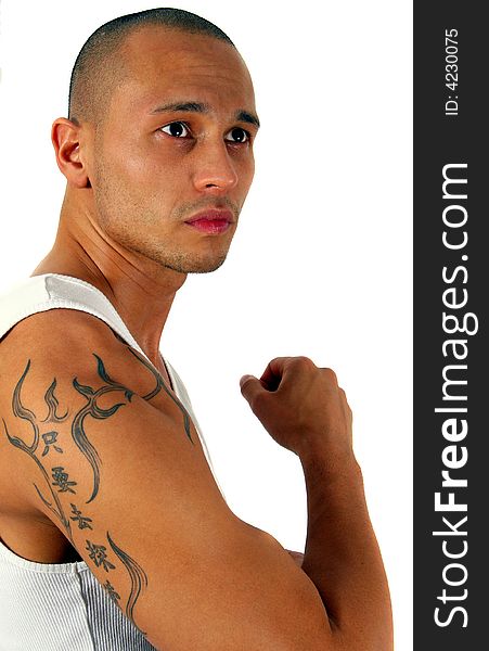 Young man showing his muscles and his tattoo - isolated over white!. Young man showing his muscles and his tattoo - isolated over white!