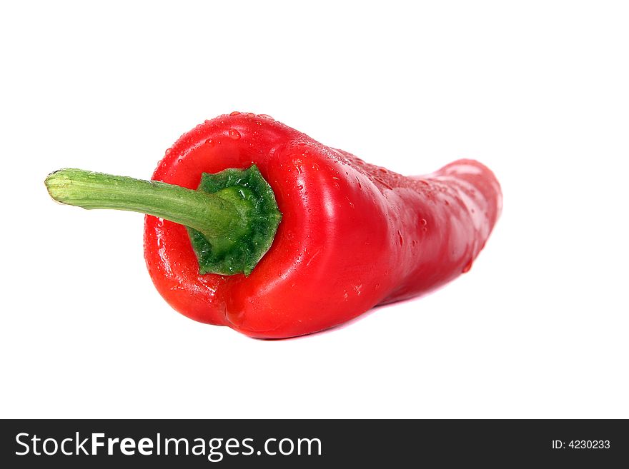 Shot of red pepper with waterdrops on it - over white background.