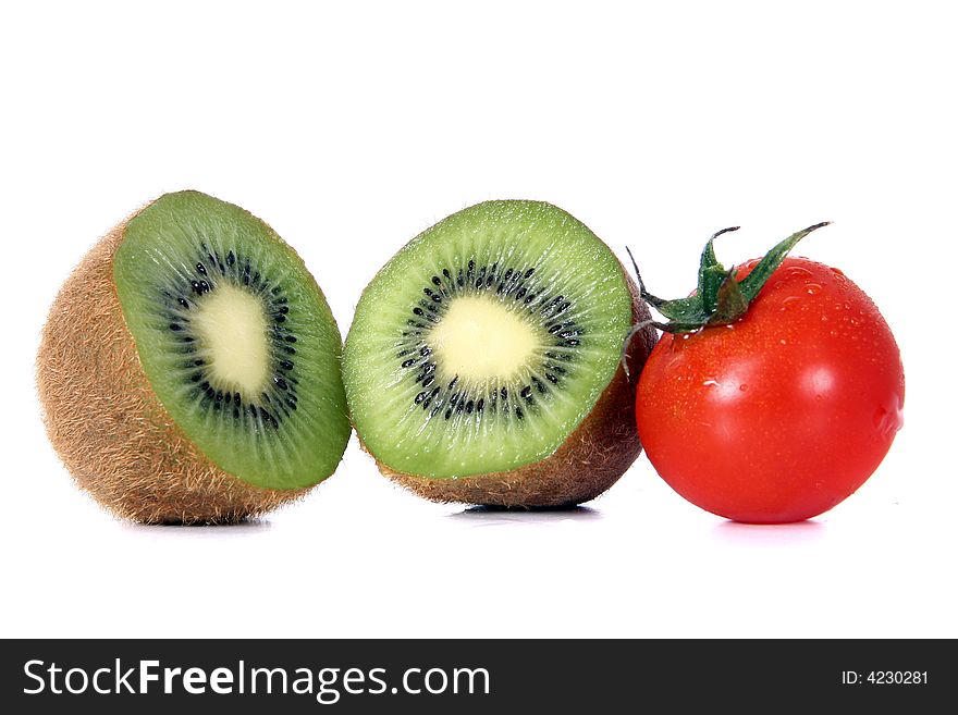 Shot of a green kiwi and a red tomatoe - wet and juicy - over white background. Shot of a green kiwi and a red tomatoe - wet and juicy - over white background.