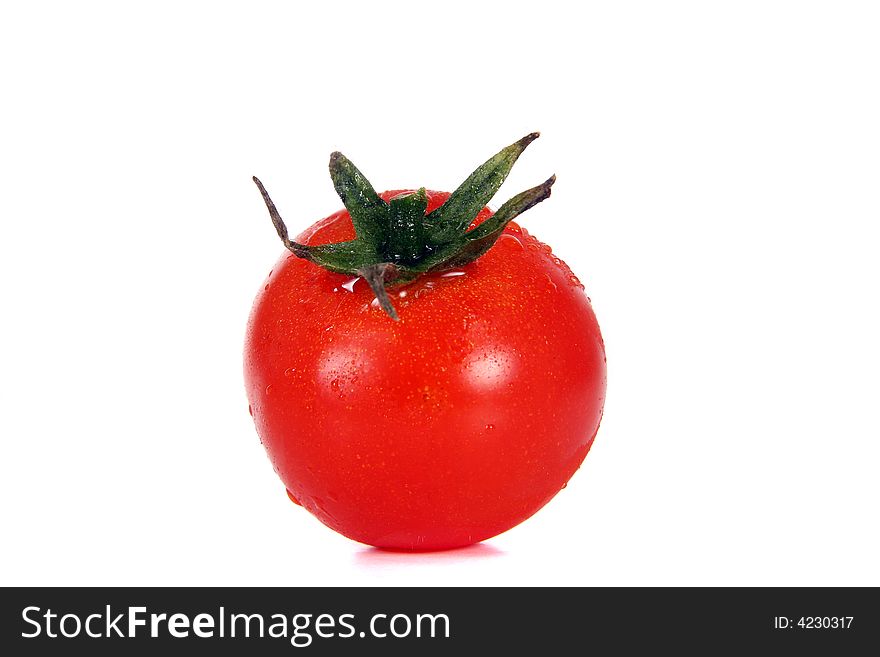A red tomato with waterdrops over white background.
