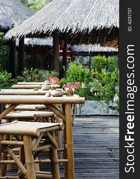 Table and chairs at an outdoor bar in the tropics - travel and tourism.