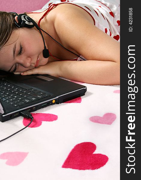 Tired romantic girl is sleeping near the laptop