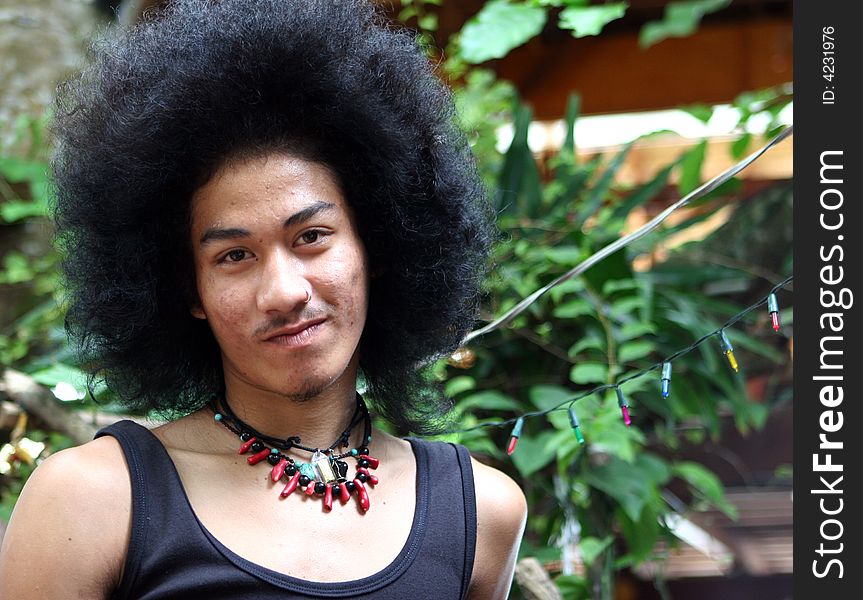 Portrait of a Thai man with a big afro.