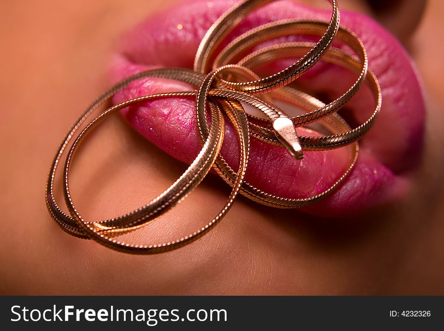 Beautiful young woman lips with silver snake shaped necklace. Beautiful young woman lips with silver snake shaped necklace