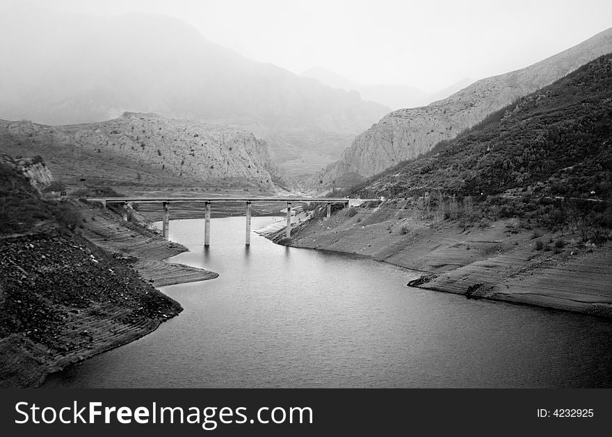 Shores of the mountains jointed by a bridge