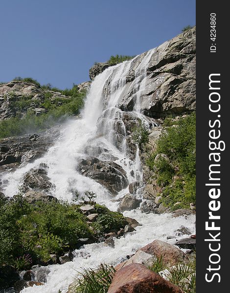 A large waterfall is in mountains