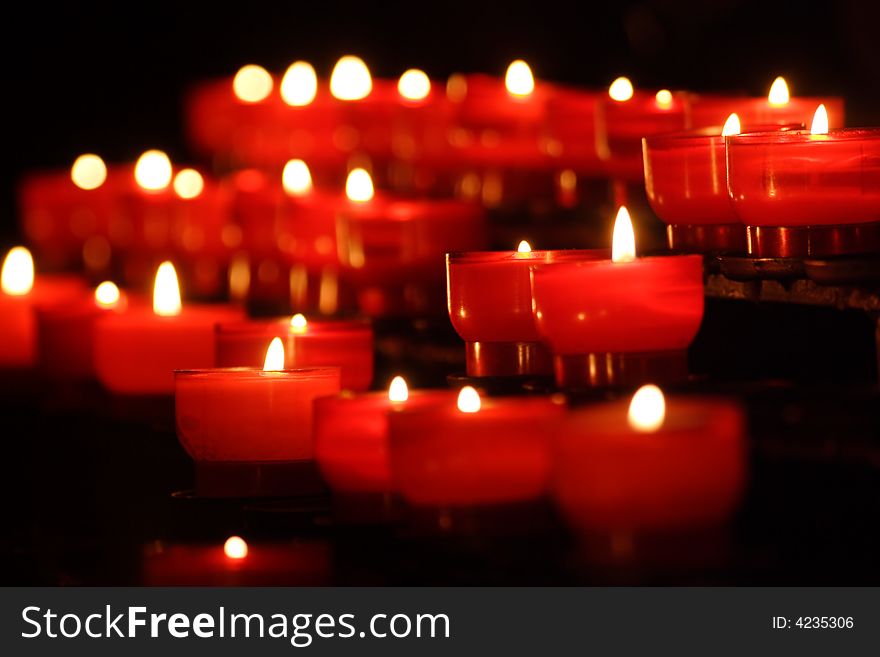 Small candles in rows in a church