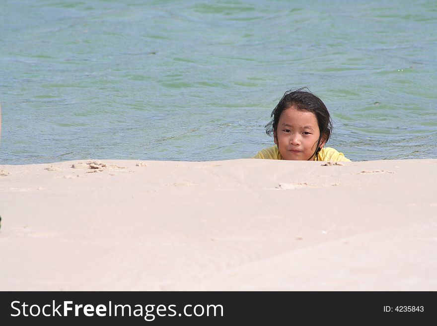 Korean Girl relaxing in the water at the beach. Korean Girl relaxing in the water at the beach