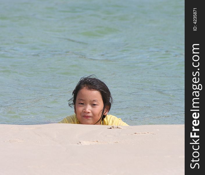 Korean Girl relaxing in the water at the beach. Korean Girl relaxing in the water at the beach