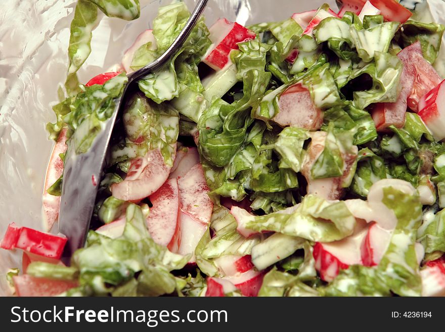 Fresh colorful delicious salad with spoon