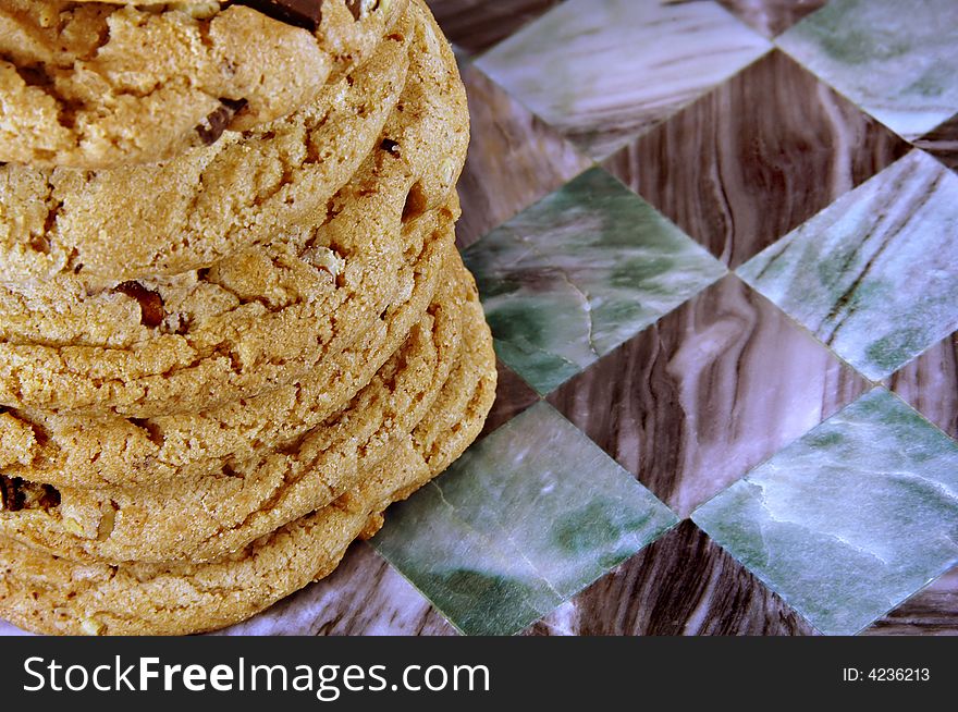 Stack of fresh chocolate chip cookies on marble checkerboard. Stack of fresh chocolate chip cookies on marble checkerboard.