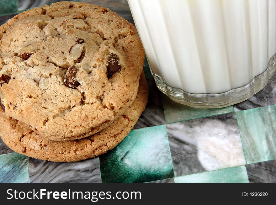 Stack of fresh chocolate chip cookies and milk.