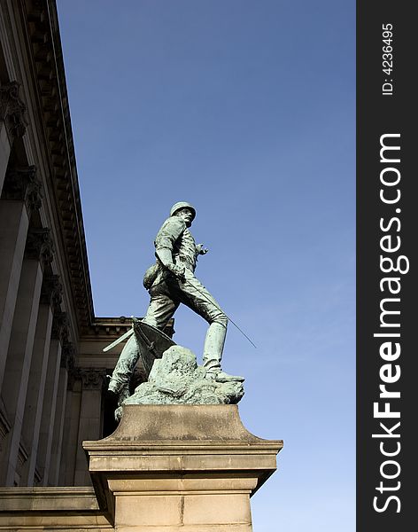 Copper statue of a soldier on a stone plinth with St Georges Hall in the background in Liverpool the capital of culture for 2008. Copper statue of a soldier on a stone plinth with St Georges Hall in the background in Liverpool the capital of culture for 2008