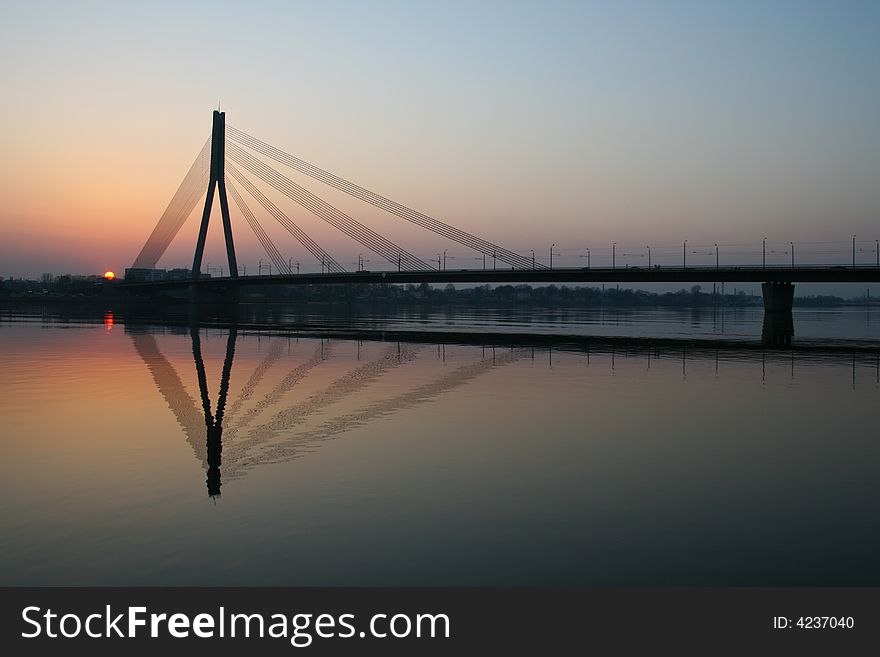 Sunset behind a suspension bridge in Riga, Latvia. Sunset behind a suspension bridge in Riga, Latvia