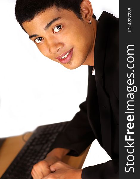 Young handsome man at front of computer. Young handsome man at front of computer