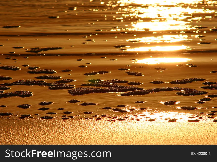 A reflection on the sand and bubbles of a sunset. A reflection on the sand and bubbles of a sunset
