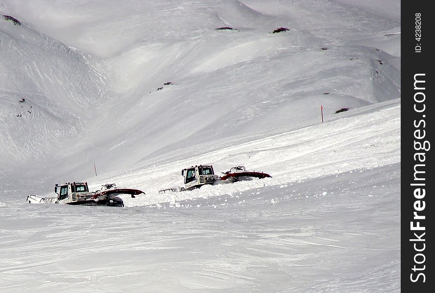 Two machines preparing a ski run. Two machines preparing a ski run.