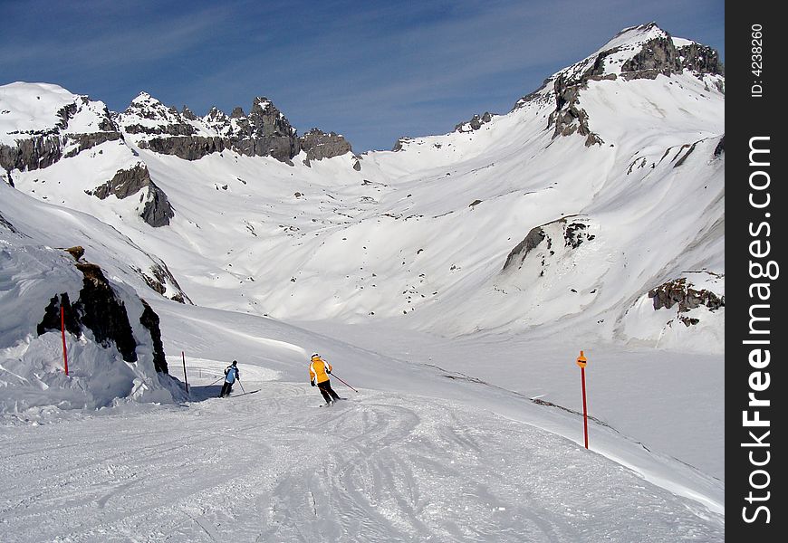 Ski run between rugged rocky mountains in the ski area of Flims Laax in the east of Switzerland. Ski run between rugged rocky mountains in the ski area of Flims Laax in the east of Switzerland.