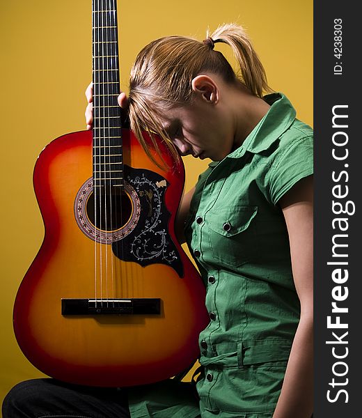 Girl in green dress with guitar in inspiration. Girl in green dress with guitar in inspiration