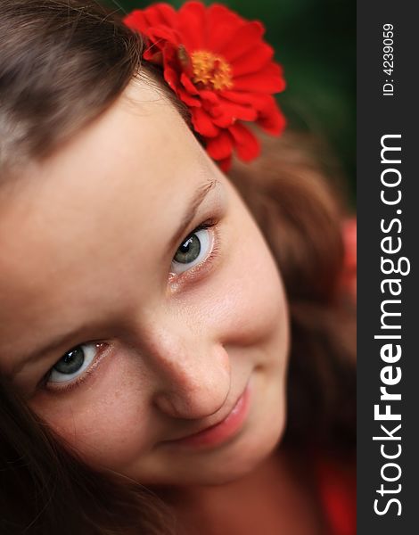 Young girl smile with red flower in a hair. Young girl smile with red flower in a hair.