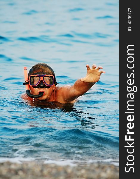 Man in diving mask in sea. Man in diving mask in sea