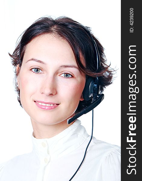 A smiling girl speaks by headphone. A smiling girl speaks by headphone