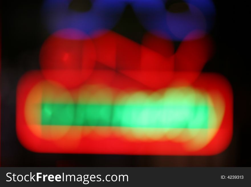 Defocused blurred neon sign background at night. Defocused blurred neon sign background at night