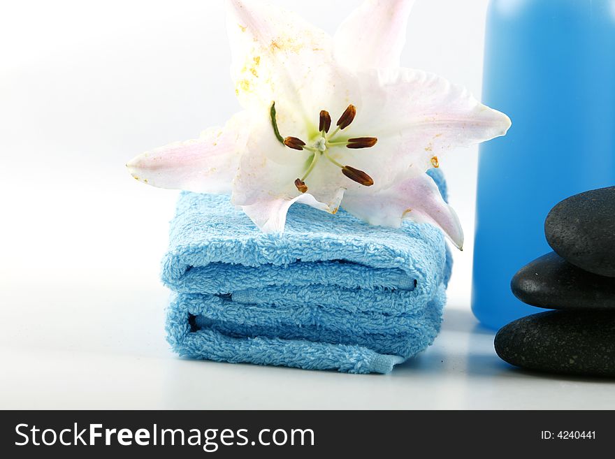 Blue towels and fresh lily on white color background