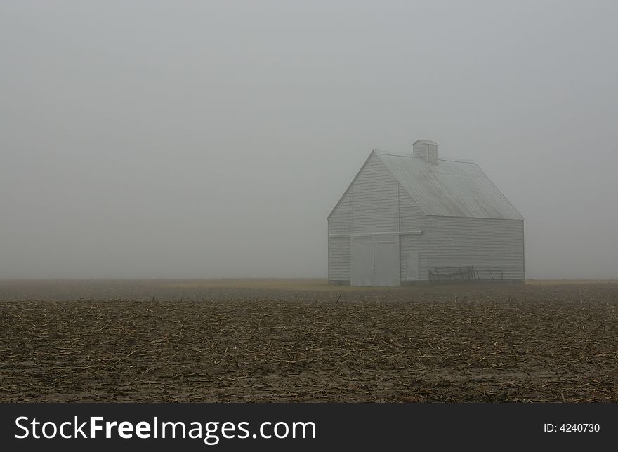 An isolated barn, on a foggy winter morning. An isolated barn, on a foggy winter morning.