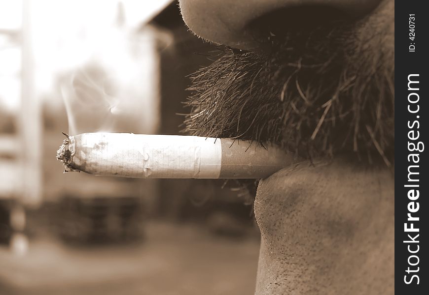 A close-up on a face who is smoking cigarette. A close-up on a face who is smoking cigarette.