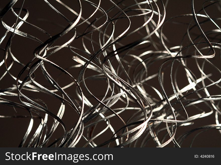 Silver swirling grass like decorations arranged in a vertical fashion. Silver swirling grass like decorations arranged in a vertical fashion.