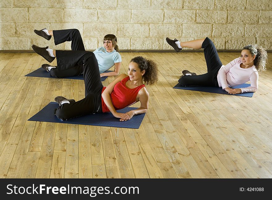 Young women exercising on mat