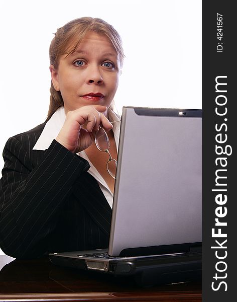 Professional woman working on convertible notebook laptop computer looking at viewer with raised eyebrows. Natural look with minimal makeup. Professional woman working on convertible notebook laptop computer looking at viewer with raised eyebrows. Natural look with minimal makeup.