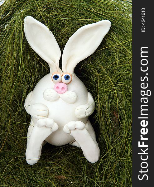 The rabbit made of egg, lays in a nest from grass. The rabbit made of egg, lays in a nest from grass.