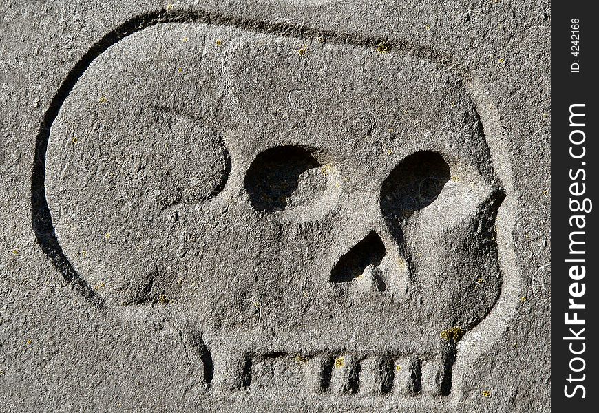 A skull engraving on a tombstone