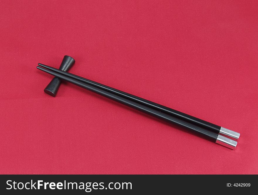 Chopsticks for a sushi on a red background