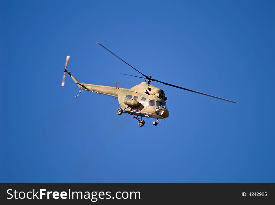 Flying helicopter on blue sky