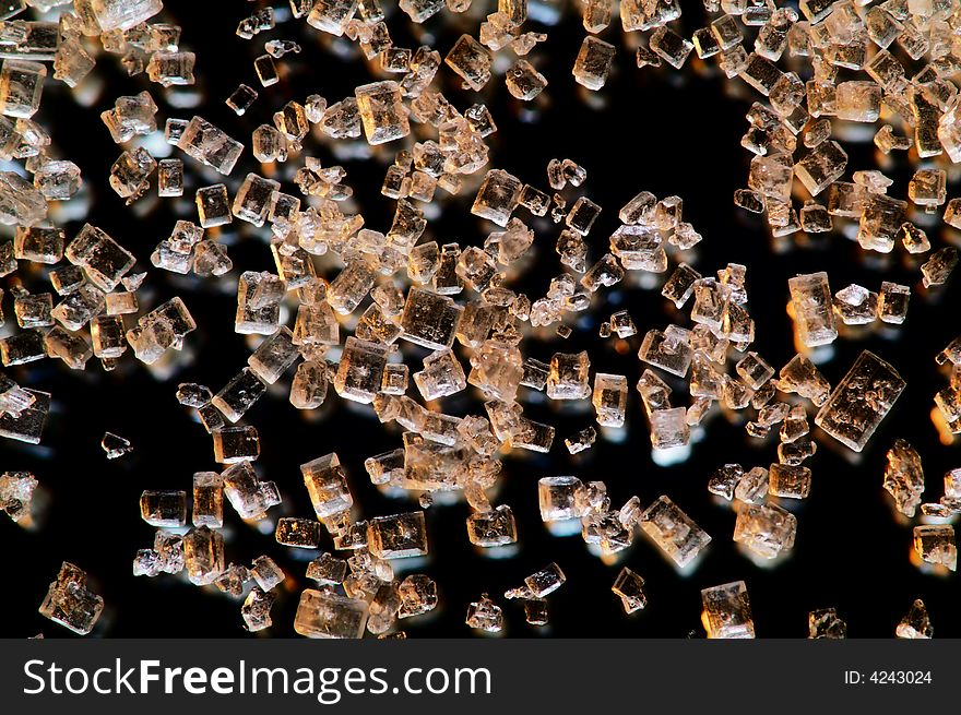 Transparent crystals are falling on black