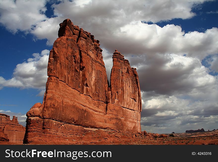 View of the red rock formations in Arches National Park with blue skyï¿½s and clouds. View of the red rock formations in Arches National Park with blue skyï¿½s and clouds