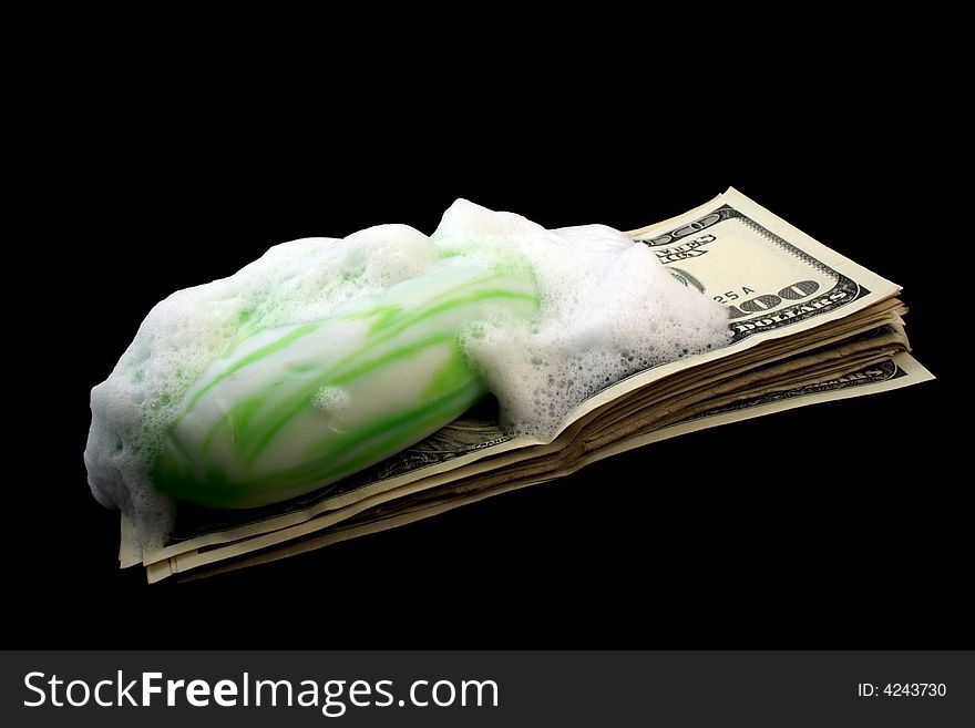 Dirty money with soap and foam isolated on black
