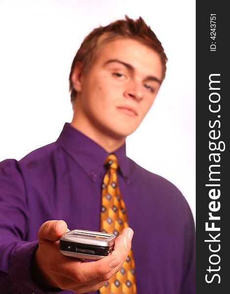 Young successful business man handing over a PDA (focus on the device), isolated on a white background.