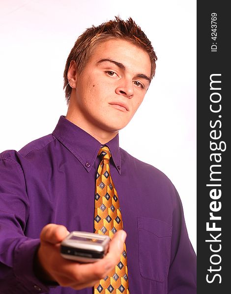 Young successful business man handing over a PDA (focus on the model), isolated on a white background.