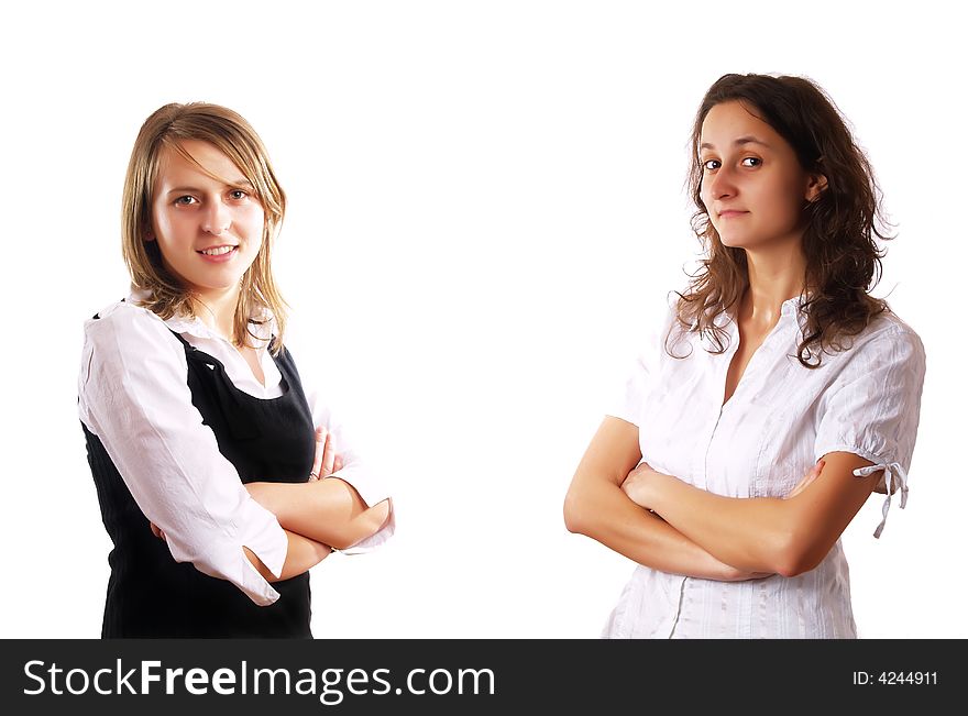 Two young businesswomen smiling on a white background. Two young businesswomen smiling on a white background