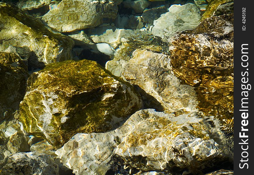 Transparent water and stones useful as texture or background. Transparent water and stones useful as texture or background