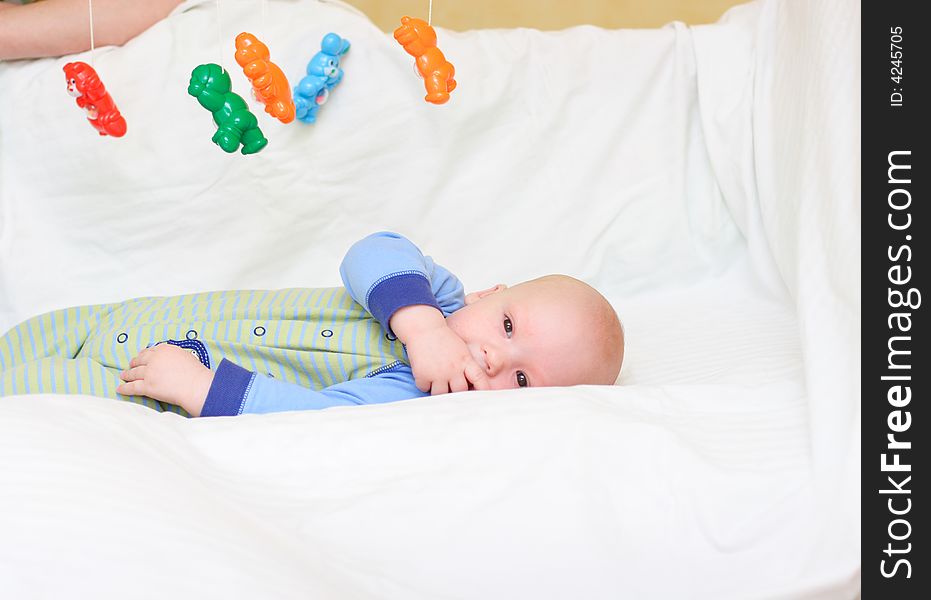 Baby playing with toys. Little boy touching the toys by finger. Baby playing with toys. Little boy touching the toys by finger