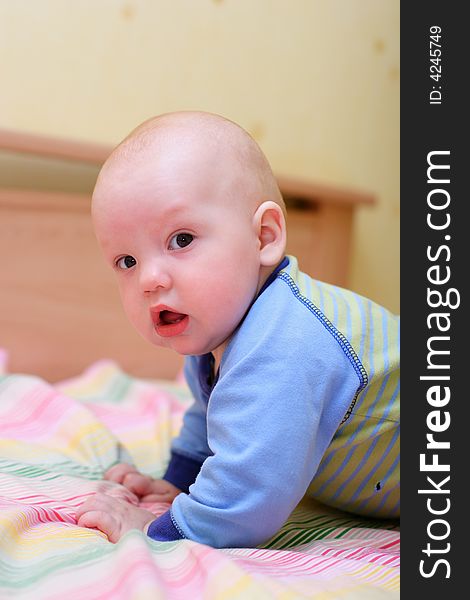 Baby at home crawling on a bed. Baby at home crawling on a bed