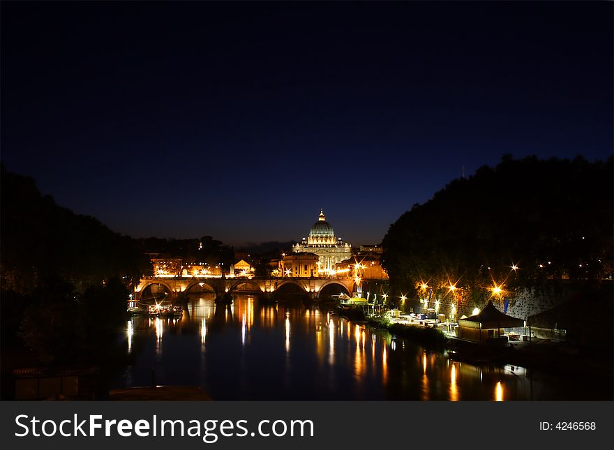 Saint Peter's Basilica in the night. View from across the Tiber River. Saint Peter's Basilica in the night. View from across the Tiber River
